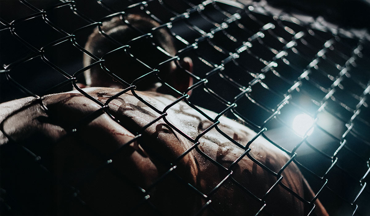 Mixed martial arts fighter in the octagon, First Round Management MMA division